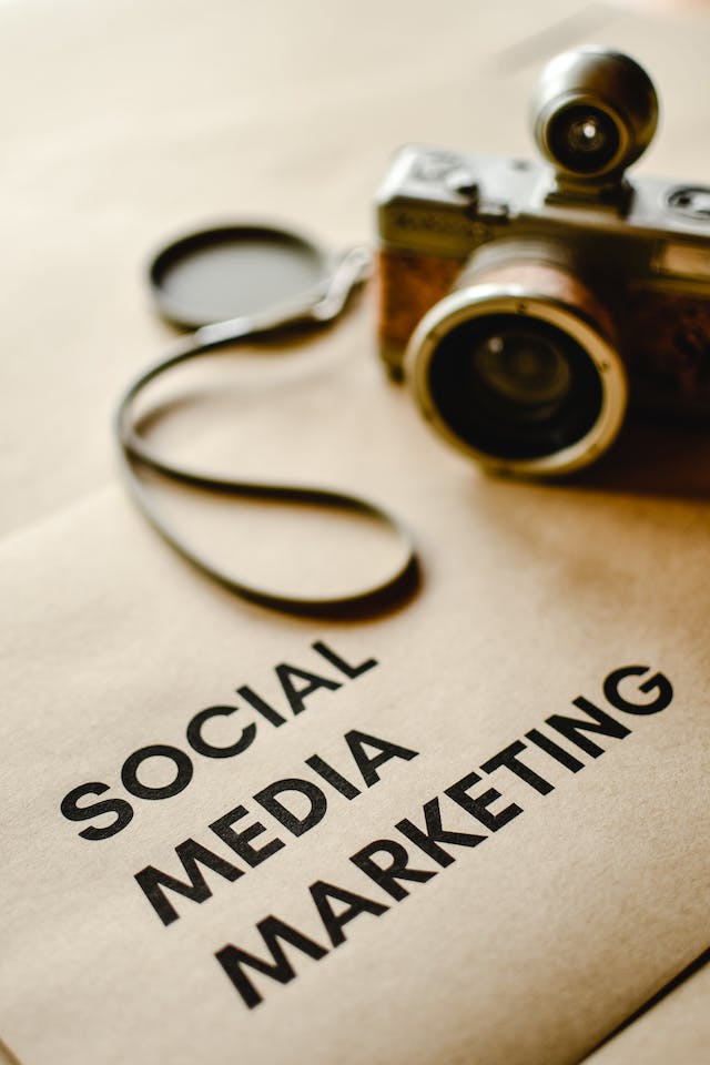 'Social Media Marketing' written on the brown paper beside the camera.