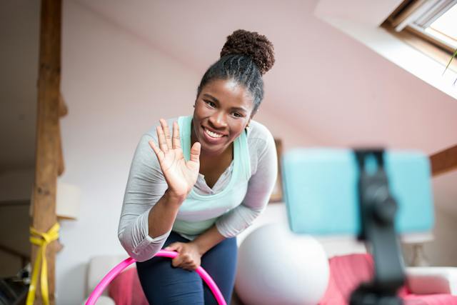 An acrobatic influencer smiles after seeing a huge number of likes on her post. 