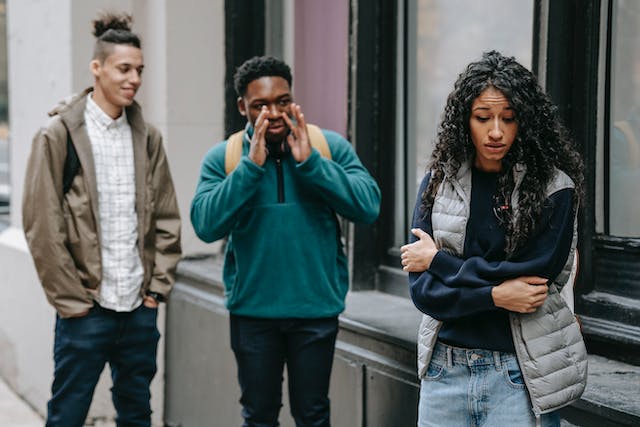 A self-conscious high school student looking uncomfortable around her peers.