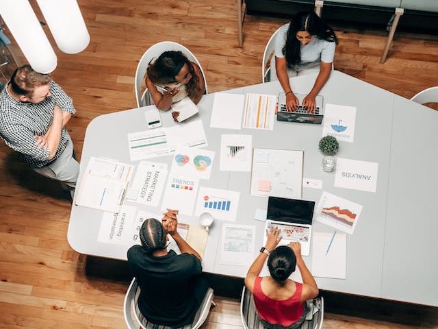 A group of people discussing marketing strategies in a room. 