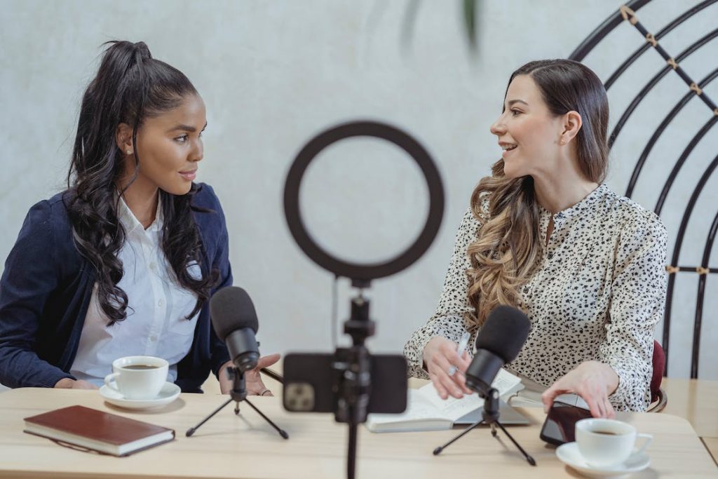 Two women are recording a podcast for their Instagram blog. 