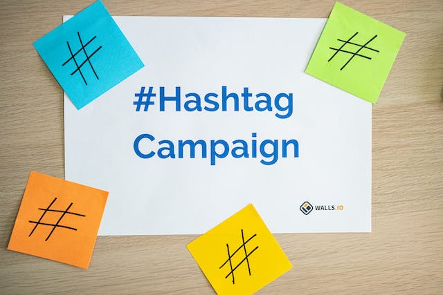 A desk that has a paper with #Hashtag Campaign printed on it 