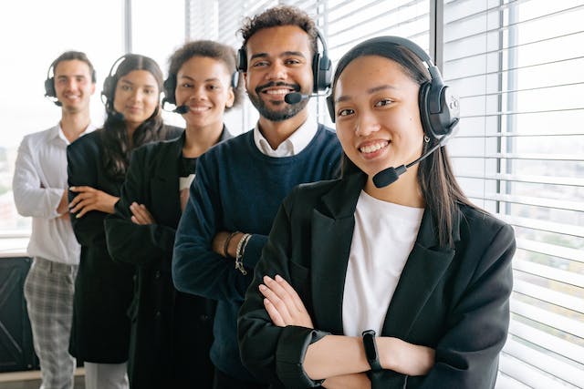 Agentes de servicio al cliente felices mirando a la cámara mientras sonríen. Agentes de servicio al cliente felices mirando a la cámara mientras sonríen.