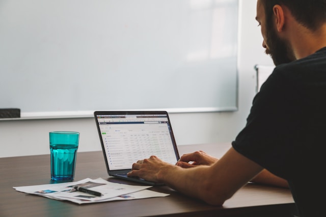 A male social media manager organizing ads on his laptop through Instagram Ad Manager.