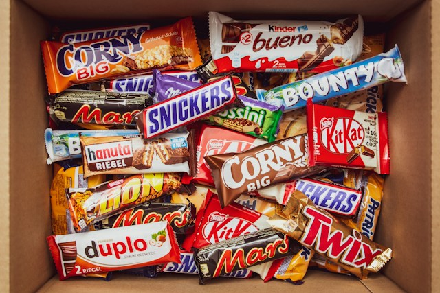 A box full of candy brads from different brands.
