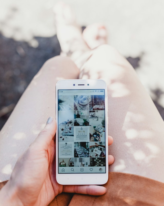 Primo piano di una donna che guarda il suo feed Instagram . 