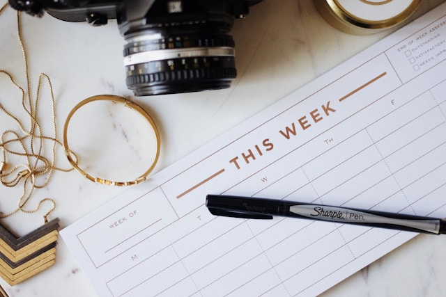 A black Sharpie marker on top of a weekly calendar.