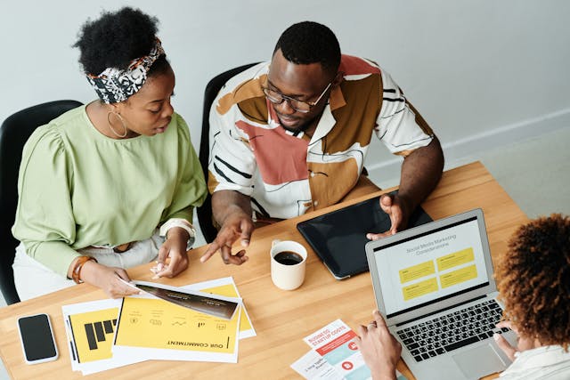 A woman thoroughly explaining the details of a project to a man.