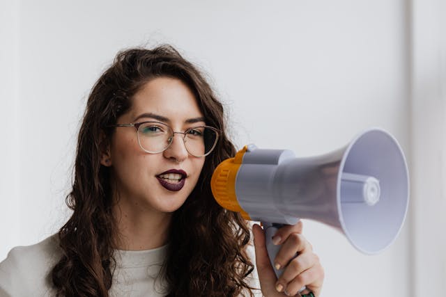 A woman about to talk into a megaphone.