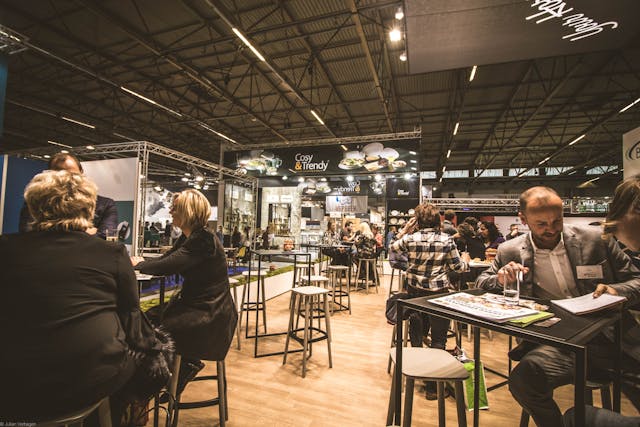 People talking and networking at an event at a café.