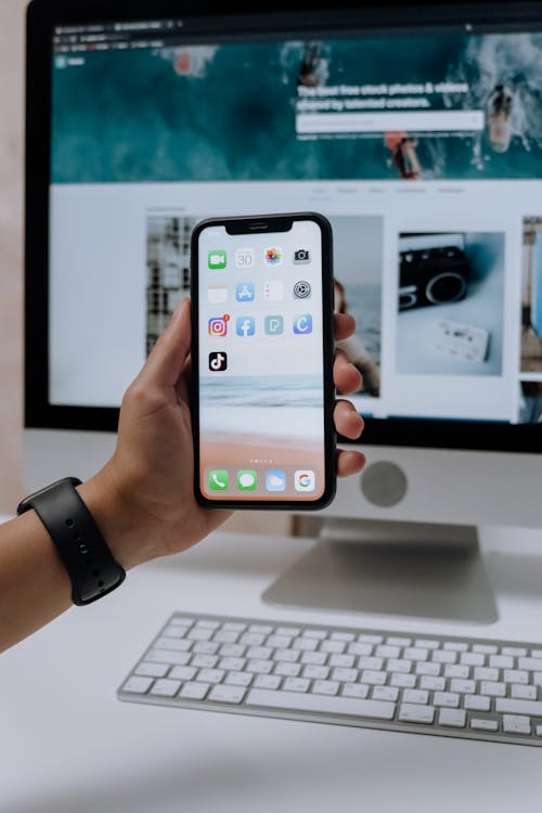 A person holding a mobile phone showing the Instagram app notification. 