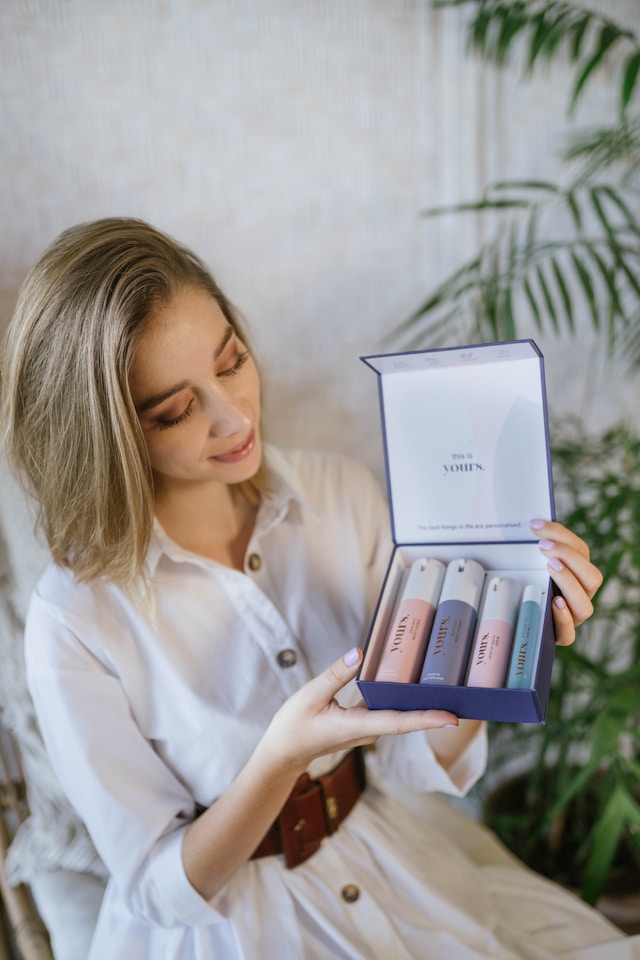 A woman unboxing products she purchased from a cosmetics brand.