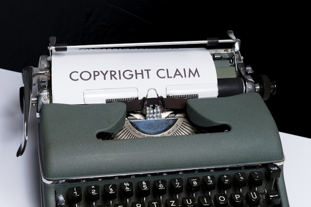 A typewriter with a piece of paper in it with the words “copyright claim.”