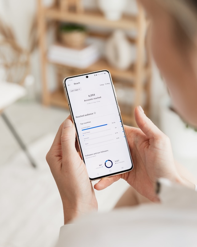 georgia-de-lotz-72JOpRSTEe8-unsplash | Path Social Someone holding their mobile phone showing the Instagram Insights dashboard.